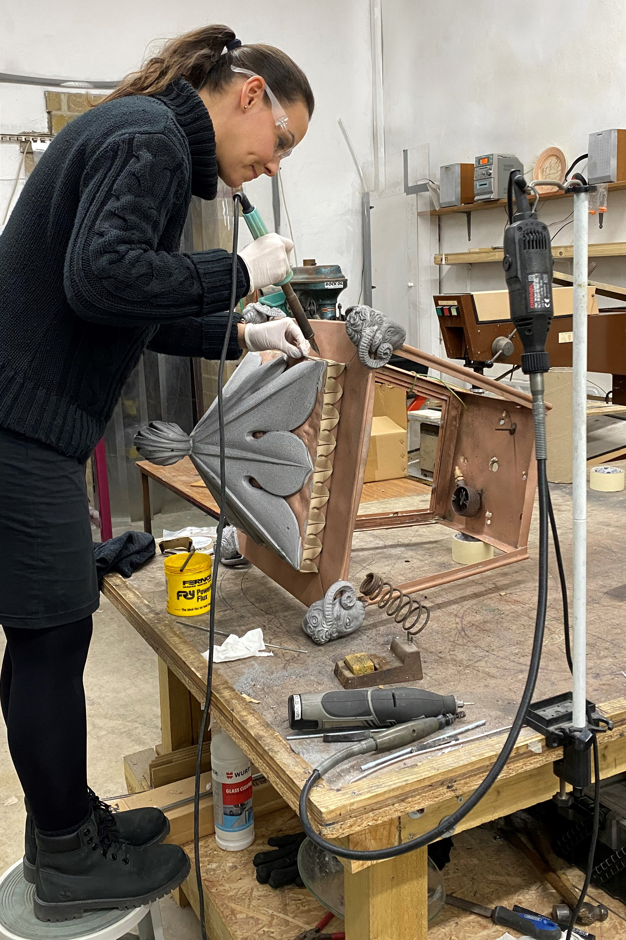 A woman soldering a lamp
