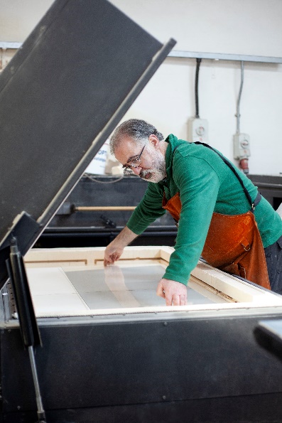 A man working on some glass